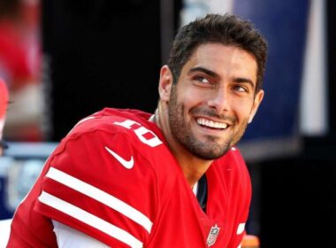 Jimmy Garoppolo holding a Raiders jersey