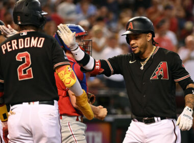 A player hitting a baseball on the field