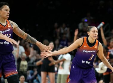 Mercury basketball team celebrating on the court