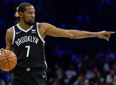 Kevin Durant holding a basketball on the court