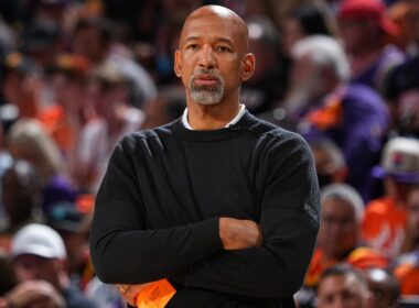 Monty Williams holding a basketball on the court