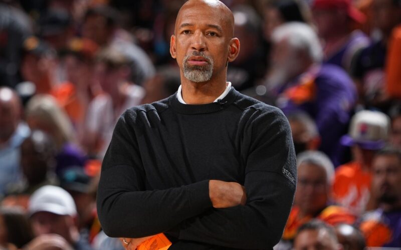 Monty Williams holding a basketball on the court