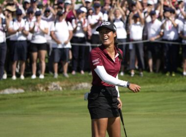 Celine Boutier holding the Evian Championship trophy